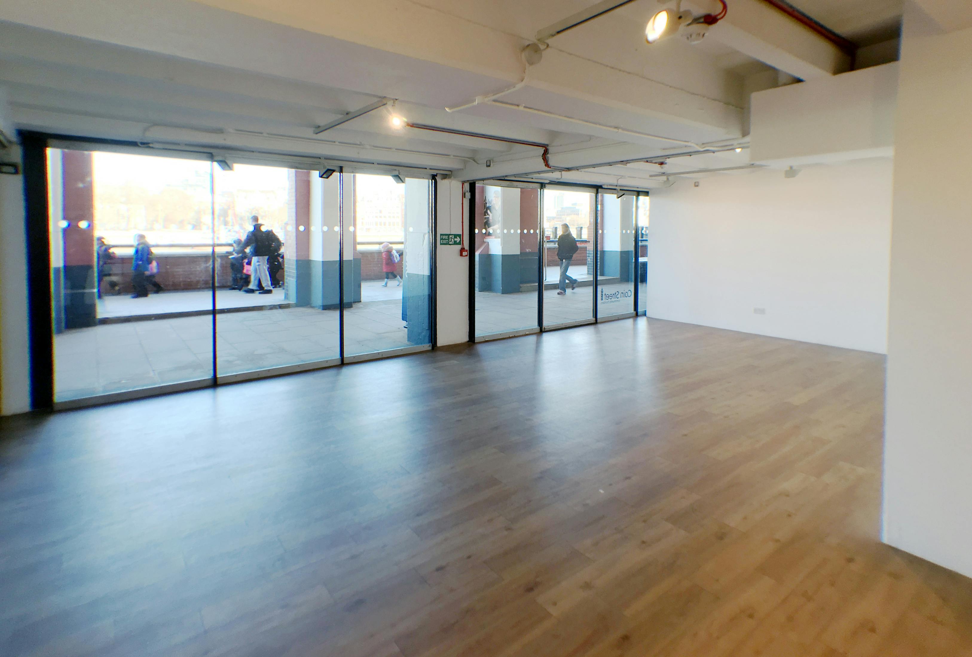 Versatile event space at gallery@oxo with large windows for natural light and gatherings.