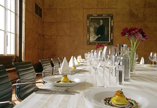 Elegant dining setup in RIBA for corporate events with fine china and floral accents.