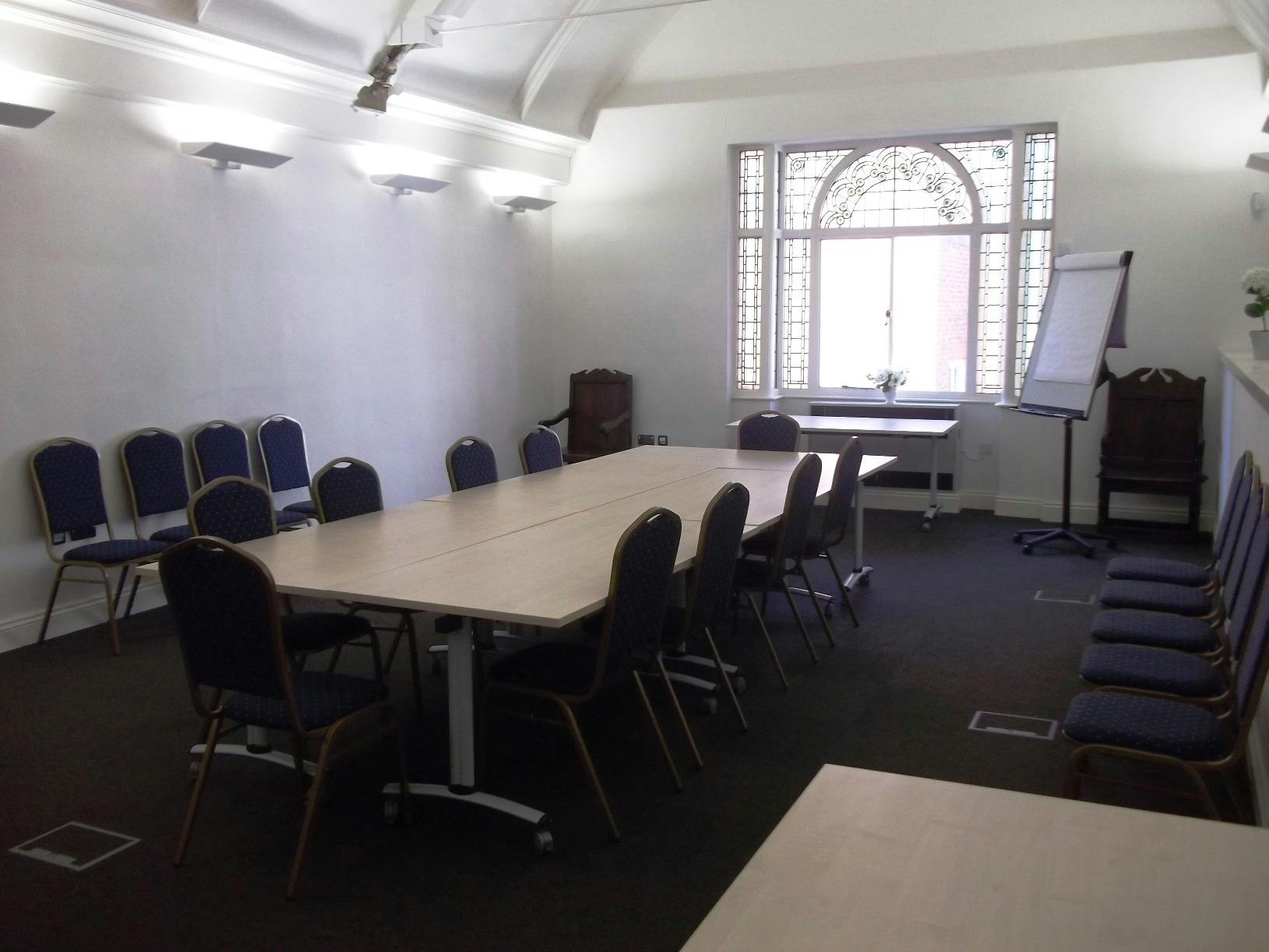 Upper Vaughan's Mansion Suite, bright meeting room with long table, ideal for workshops.