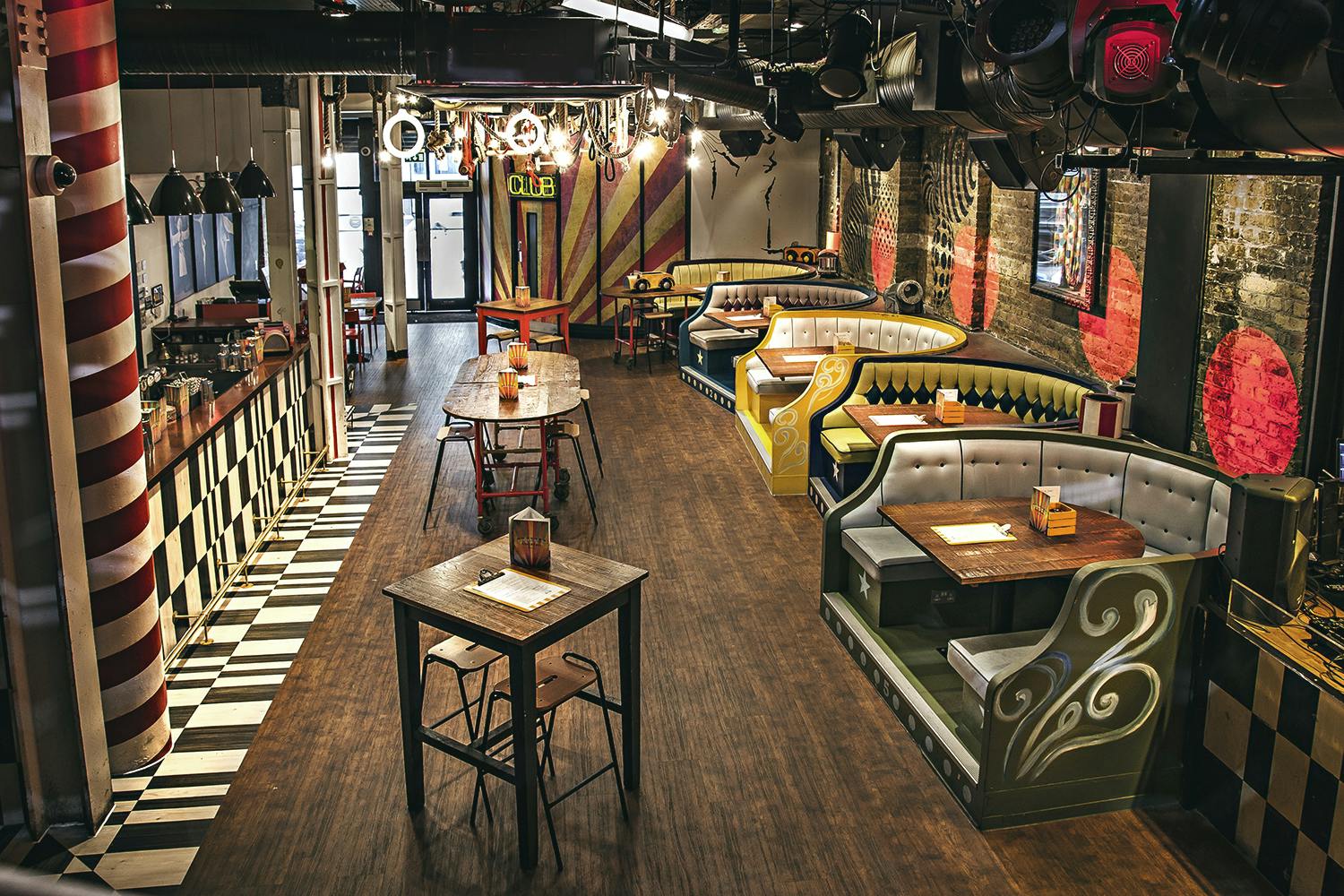 Vibrant Trapeze Bar main area with eclectic seating for events and gatherings.