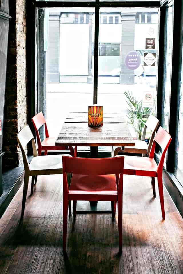 Cozy meeting space at Trapeze Bar with rustic table, ideal for gatherings and brainstorming.