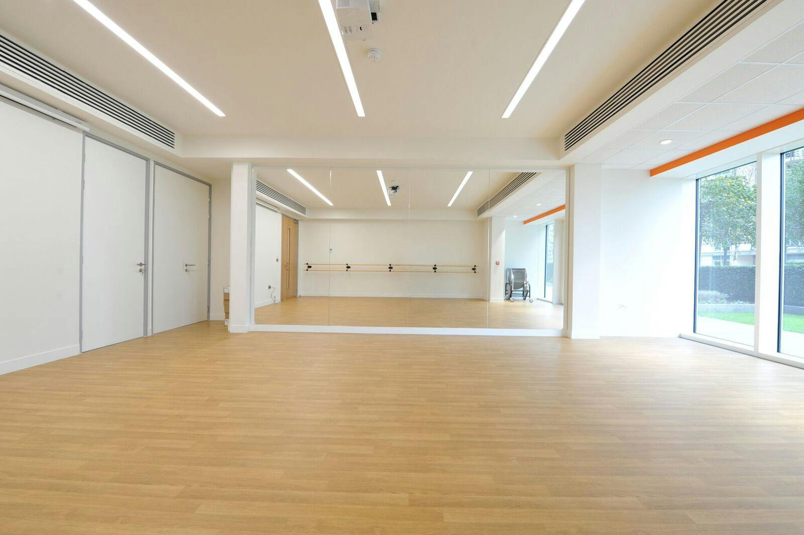 Muir-Warden Studio: bright event space with large mirror for workshops and fitness classes.