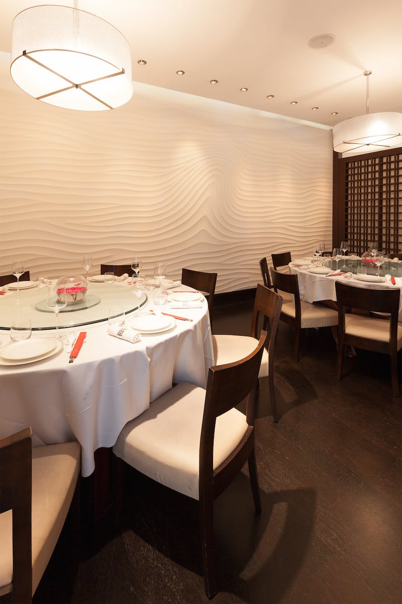Private dining room with round table, ideal for corporate events and intimate gatherings.