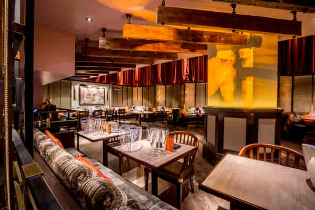 Stylish restaurant interior with wooden beams, ideal for networking events and private dinners.