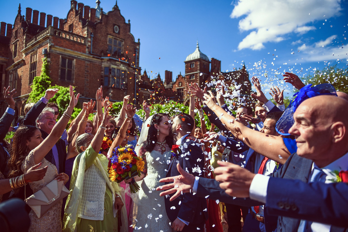 "Vibrant wedding celebration in Great Hall, Aston Hall with guests throwing confetti." - Banner