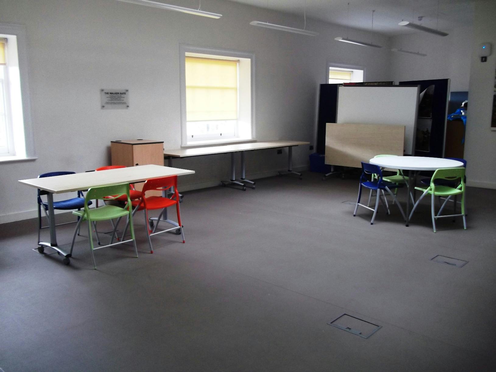 Versatile meeting space with colorful chairs at Shrewsbury Museum for workshops and events.