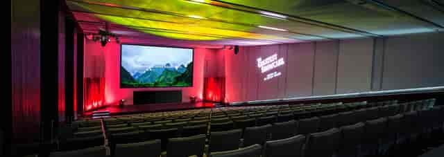 Modern corporate auditorium, tiered seating, event venue