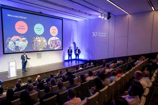 30 Euston Sq. Auditorium: Modern stage, tiered seats, conference event
