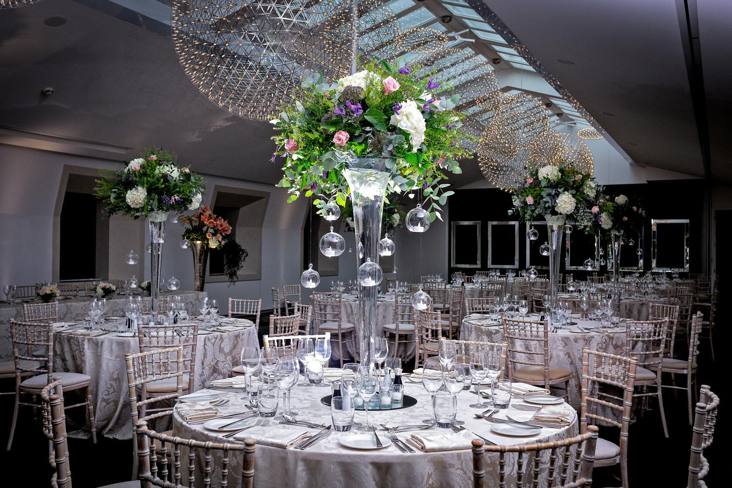 Elegant banquet hall with floral centerpieces, perfect for upscale events and weddings.