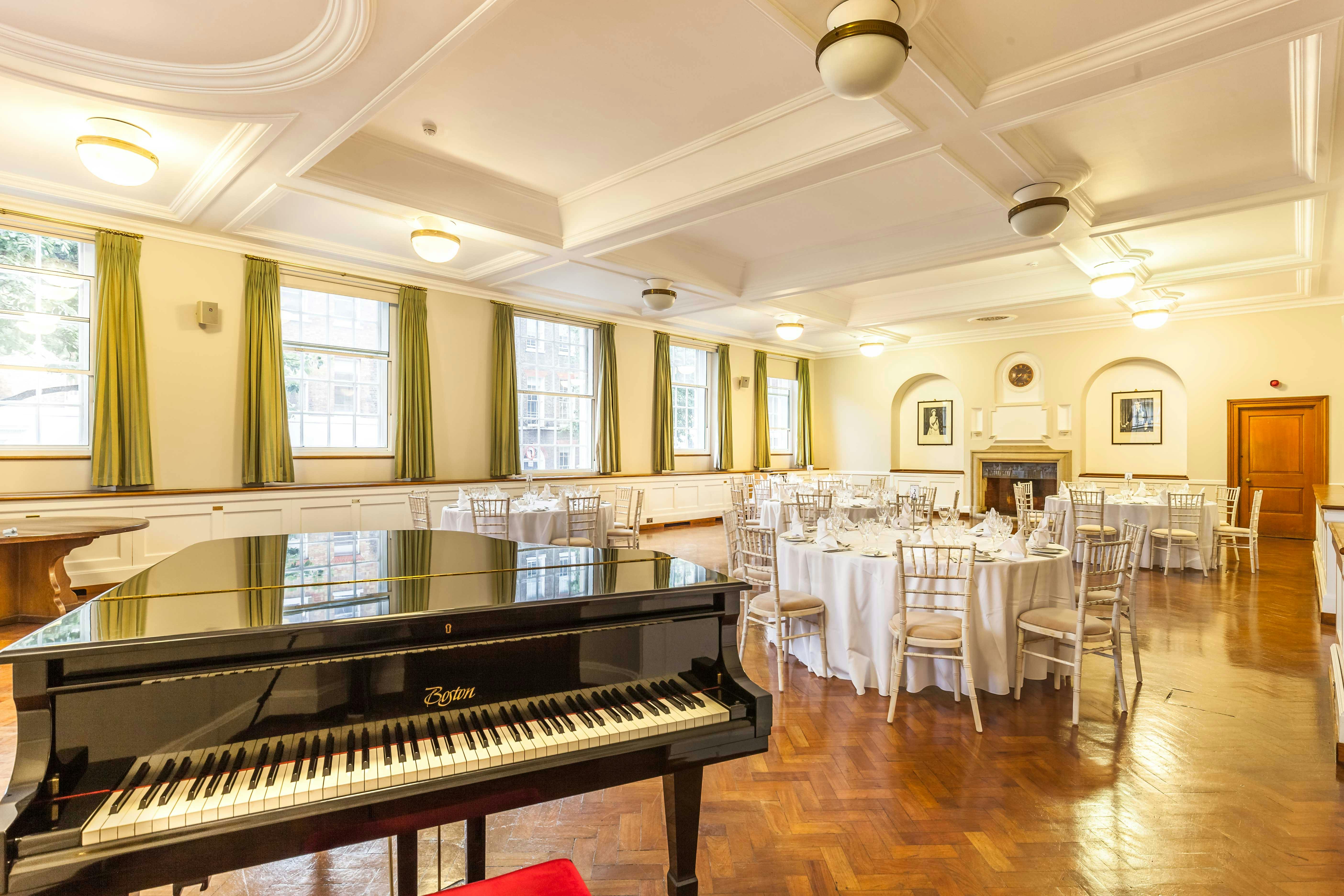 London House Large Common Room with elegant round tables, ideal for events and gatherings.