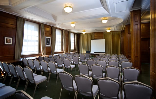 Churchill Room in Goodenough House, featuring warm wood paneling for meetings and workshops.