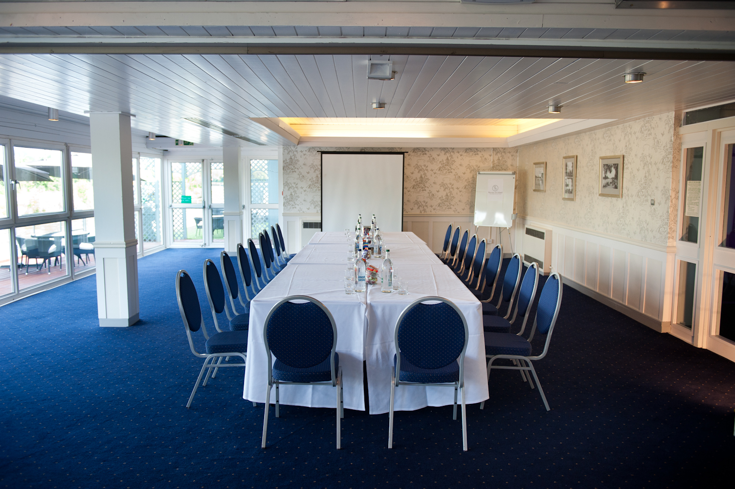 Thames Suite meeting room with elegant table setup for professional events on Ravens Ait Island. - Banner