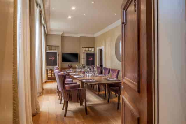 Elegant meeting room with wooden table and plush chairs at The Roseate, Reading.