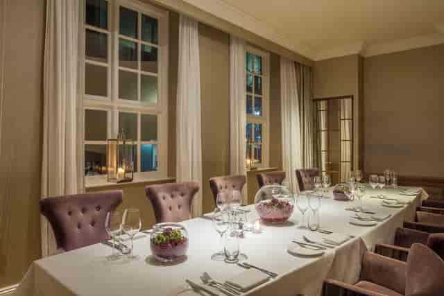 Elegant dining table in The Roseate's Cellar Room for upscale events and corporate dinners.