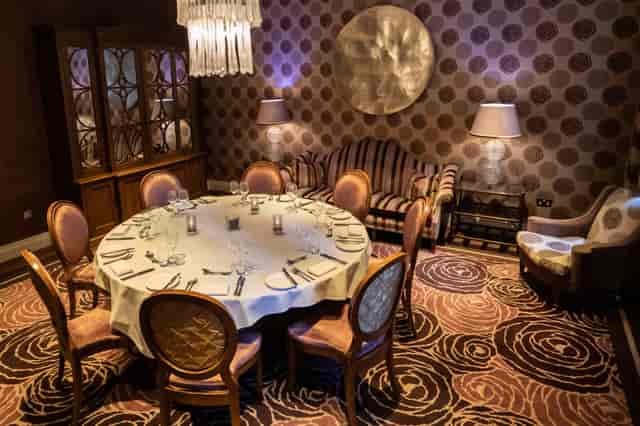 Elegant round table in The Roseate Library Room for intimate gatherings and meetings.