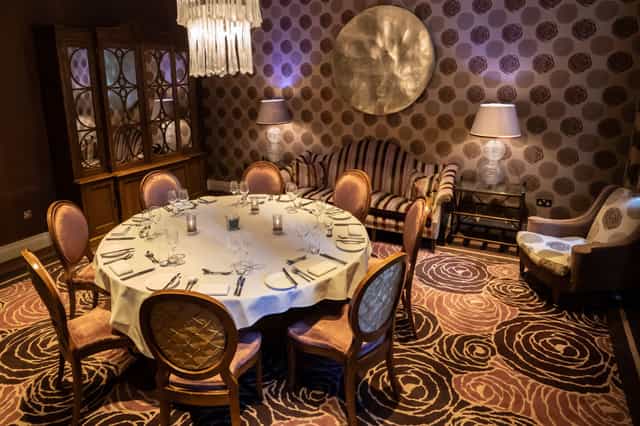 Elegant round table in The Roseate Library Room for intimate gatherings and meetings.