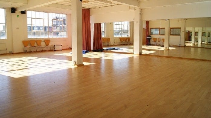 Spacious event space with wooden floor, ideal for workshops and gatherings at The Factory.