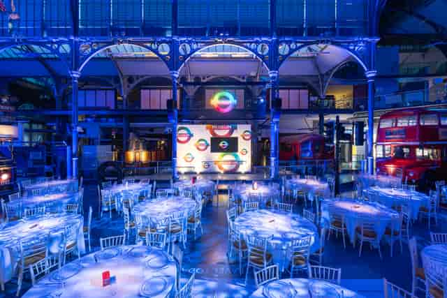 London Transport Museum gala event featuring blue uplighting and banquet seating.