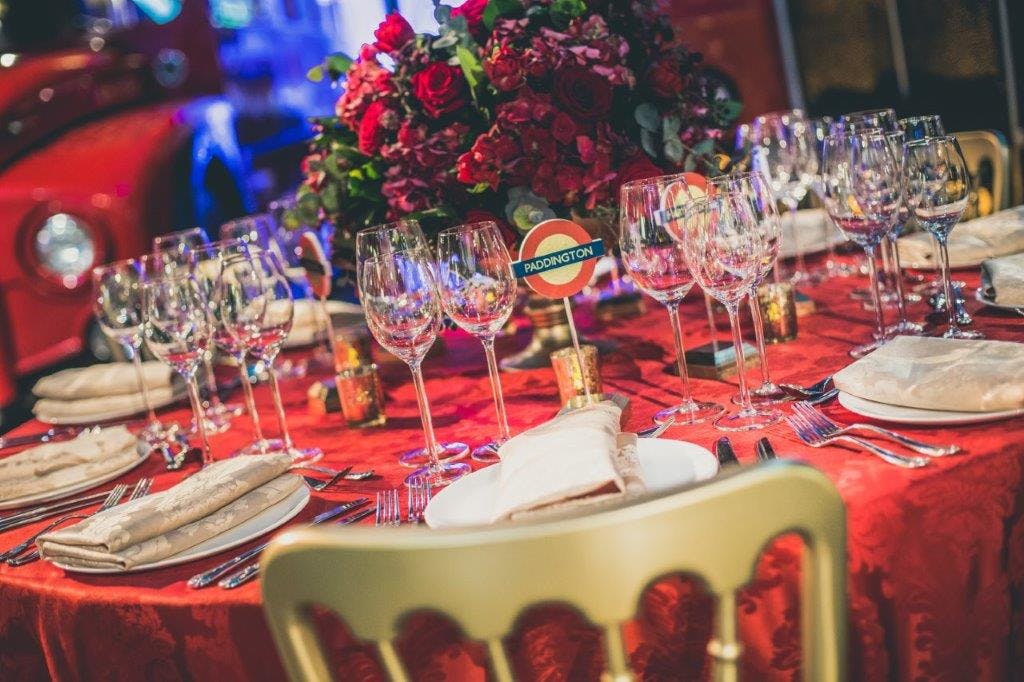 Elegant dining table with floral centerpiece at London Transport Museum event.