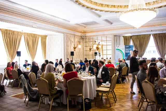 Elegant banquet room in Manchester Hall for networking event with audio-visual setup.