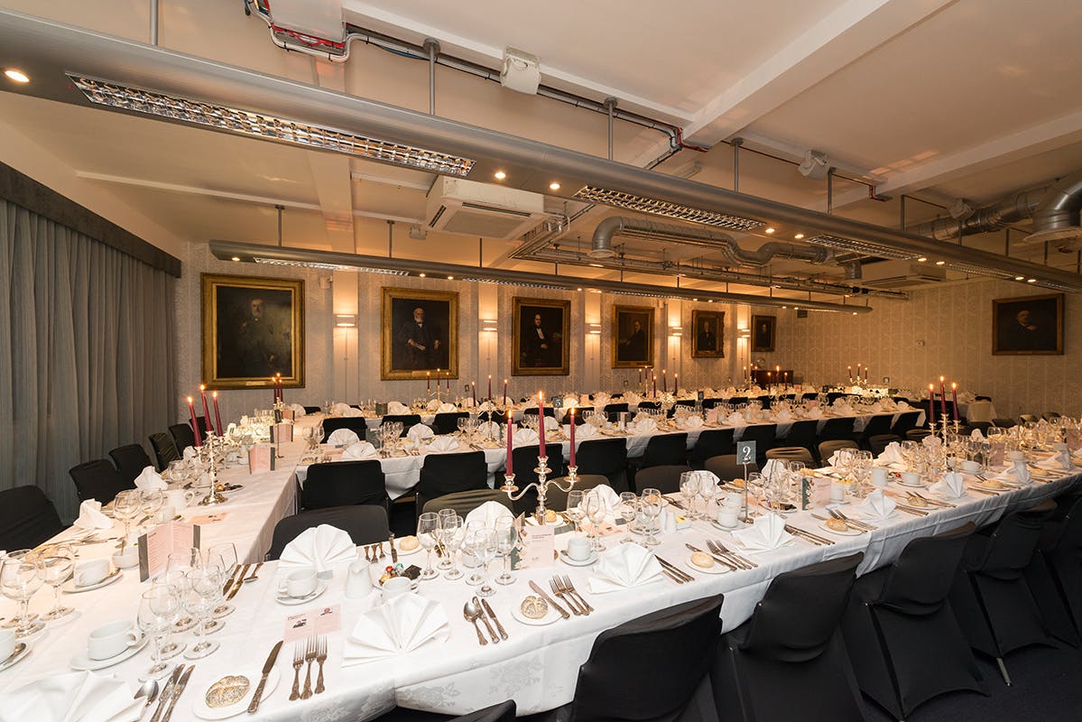 Elegant banquet hall with white linens, ideal for corporate dinners and upscale events.