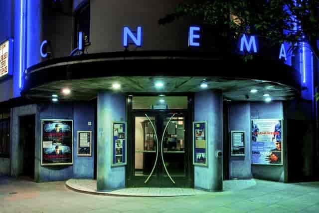 Auditorium entrance at Rio Cinema with blue neon lights, ideal for film events and screenings.