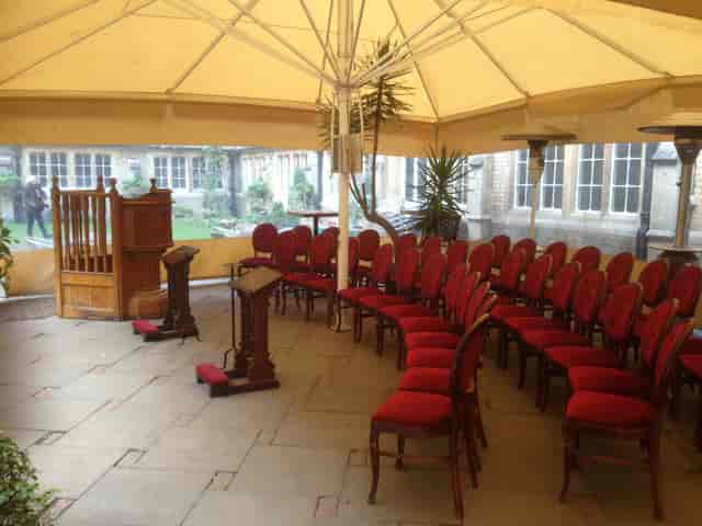 Gothic Bar outdoor event space with red chairs, ideal for weddings and workshops.