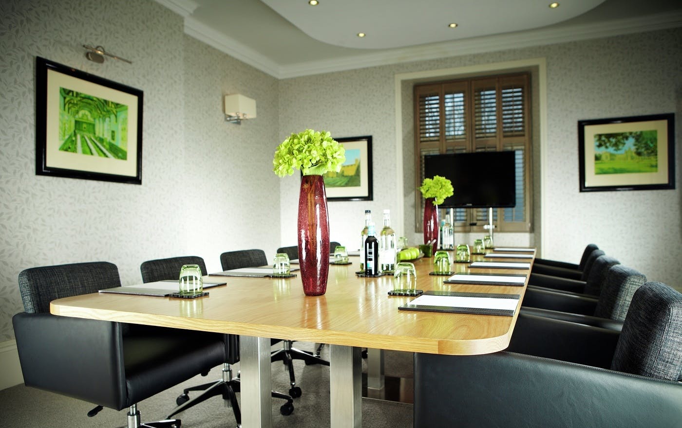 Boardroom at Alexander House Hotel, sleek table ready for professional meetings and events.