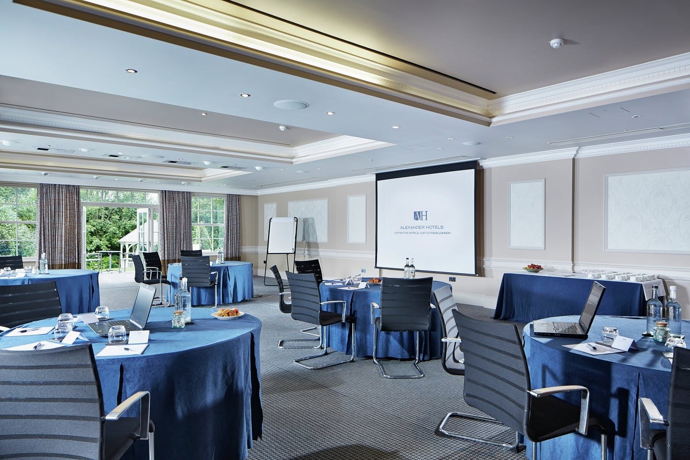 Shelley Suite meeting room with navy tables, ideal for professional events and conferences.