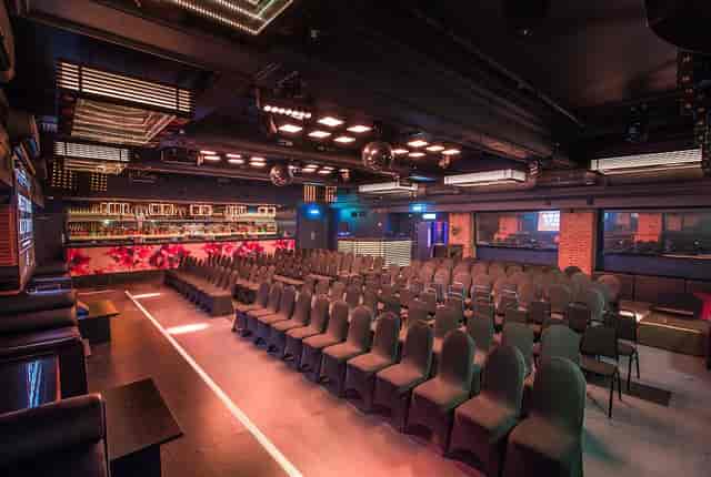 Modern event space in Sway with sleek black chairs, perfect for corporate and private events.