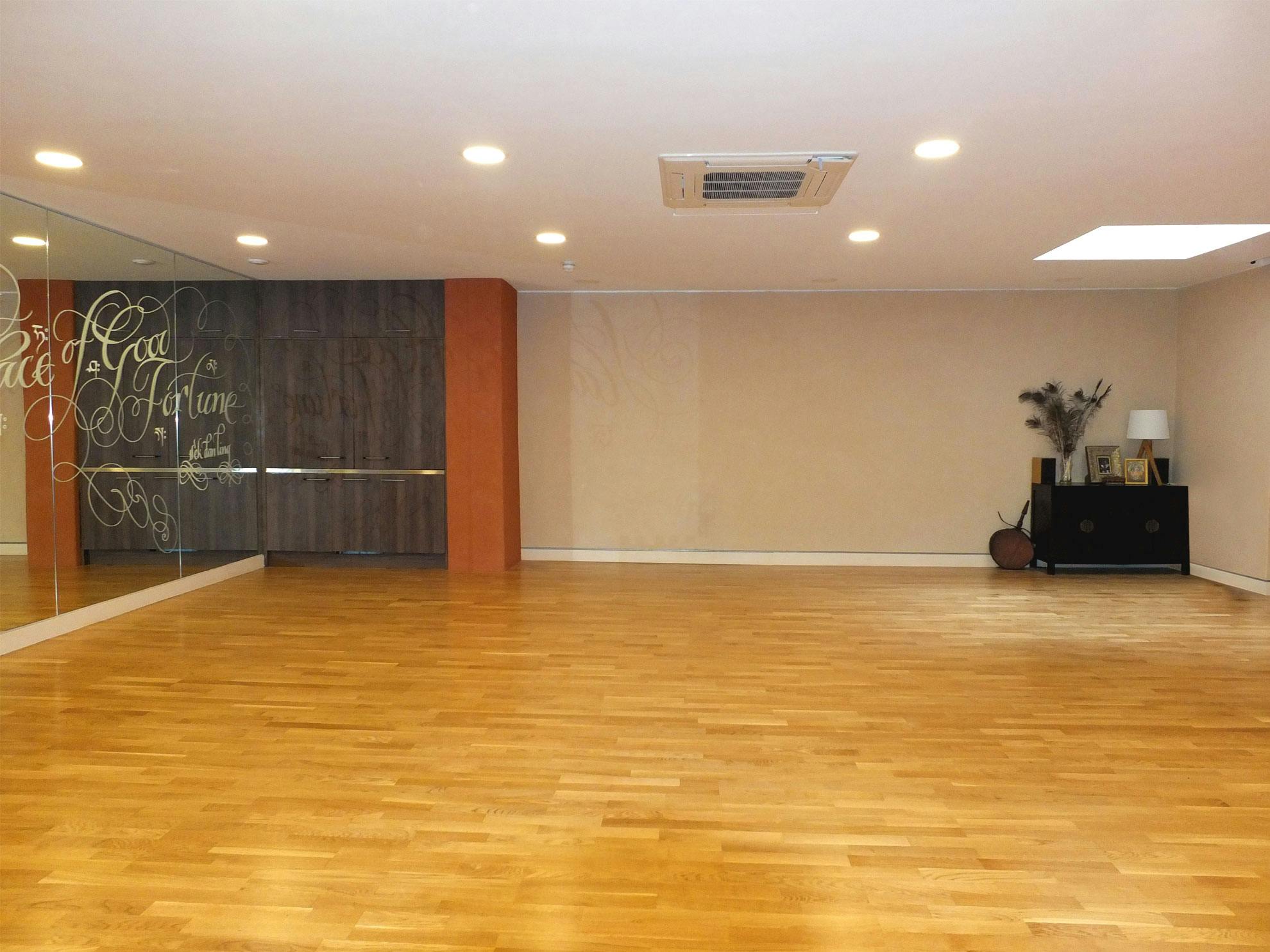 Main Room at Lekdanling Tibetan Cultural Centre, polished wood floor, ideal for workshops and yoga.