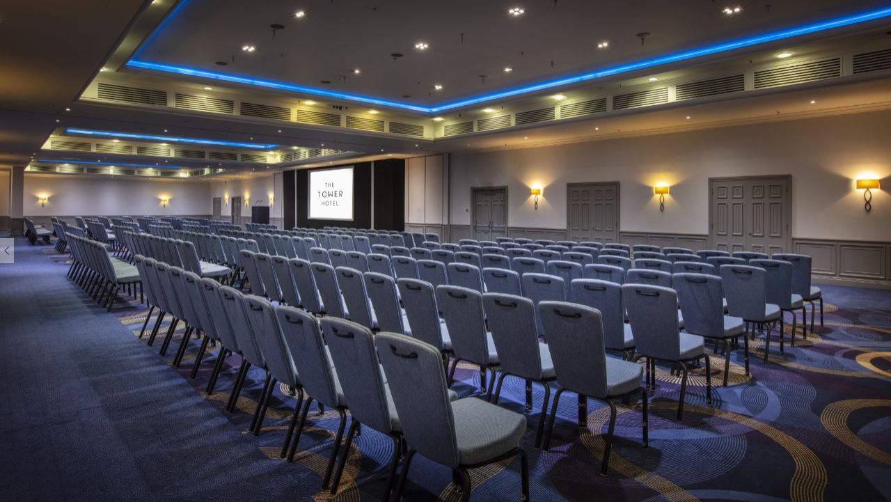 Spacious Tower Suite conference room with chairs for corporate seminars and meetings. - Banner