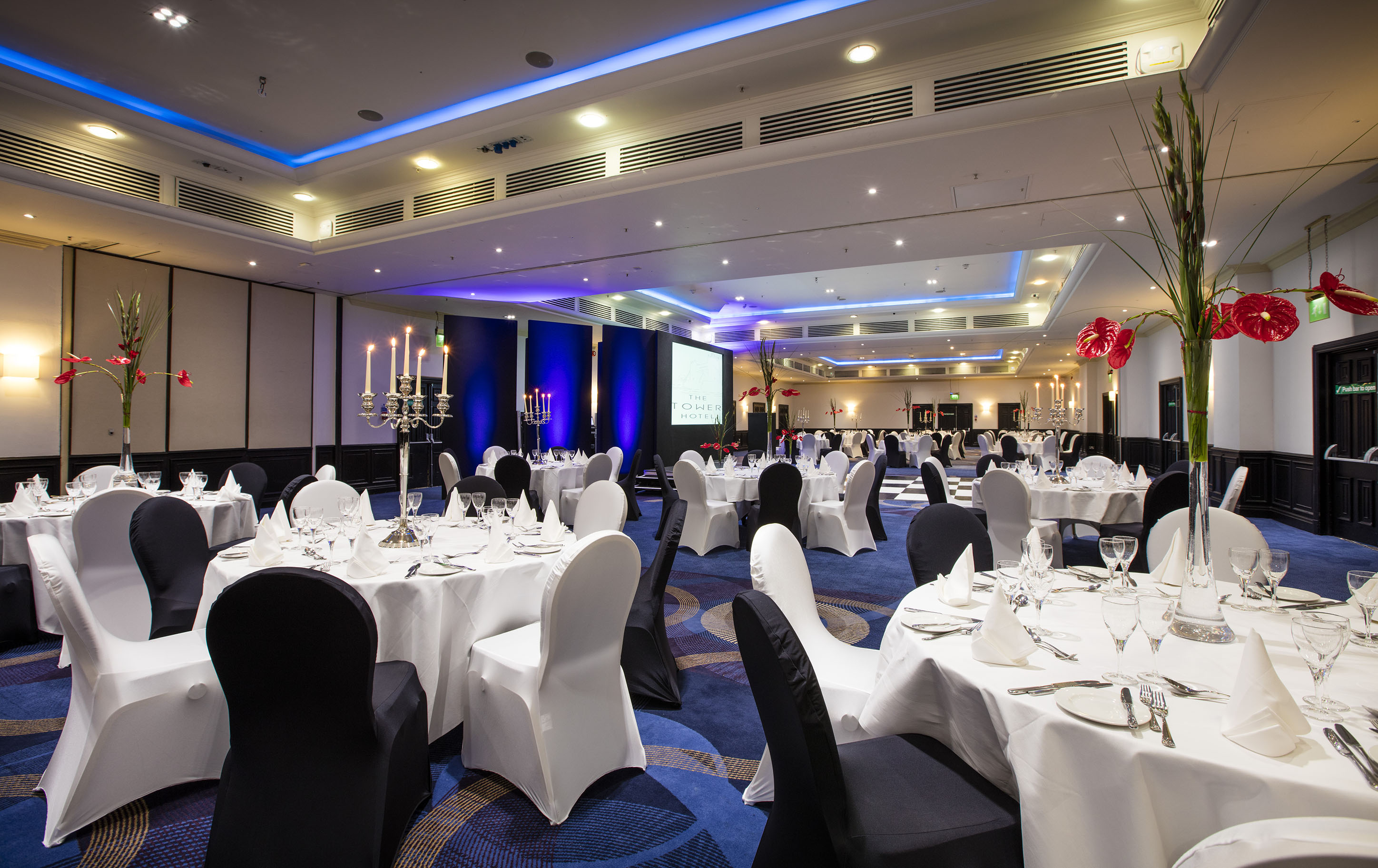Tower Suite event space with elegant tables, ideal for corporate gatherings and banquets. - Banner