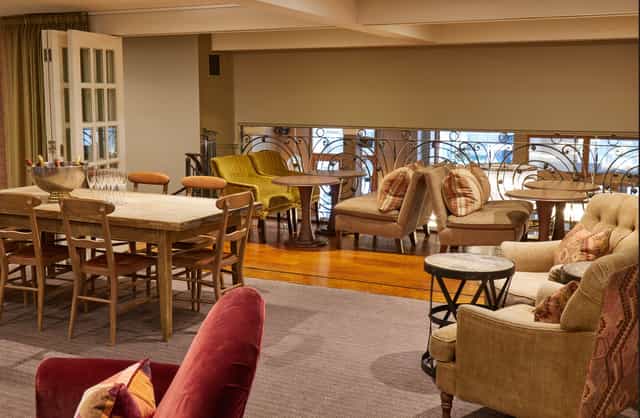 Mezzanine Lounge event space with cozy seating for networking and meetings.