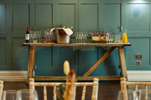 Beverage station at King Street Townhouse, featuring wine and sparkling glasses for events.