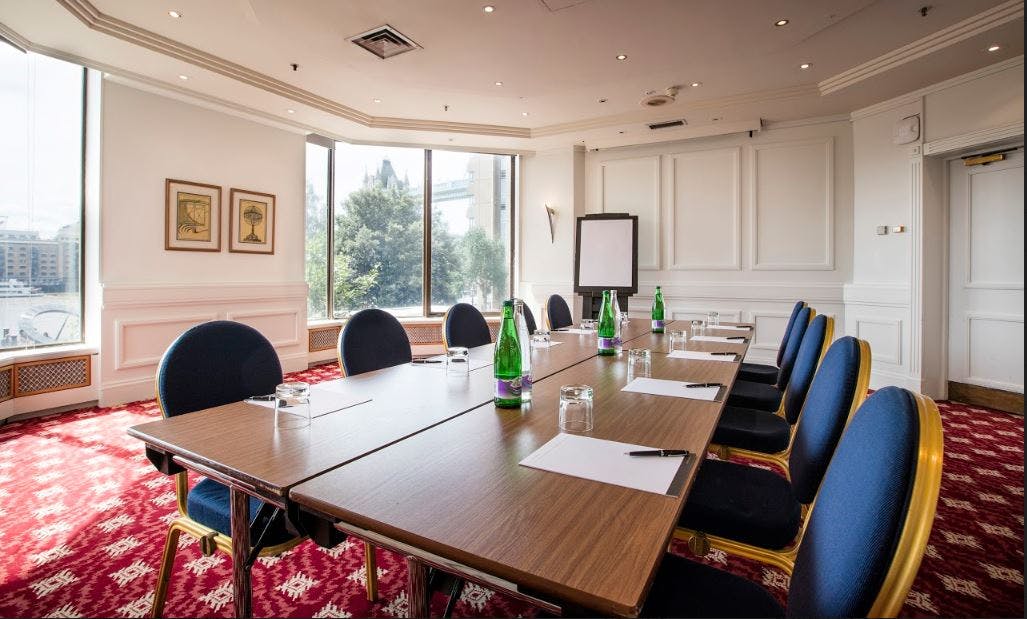 Mortimer Suite meeting room with large table and blue chairs, ideal for corporate events.