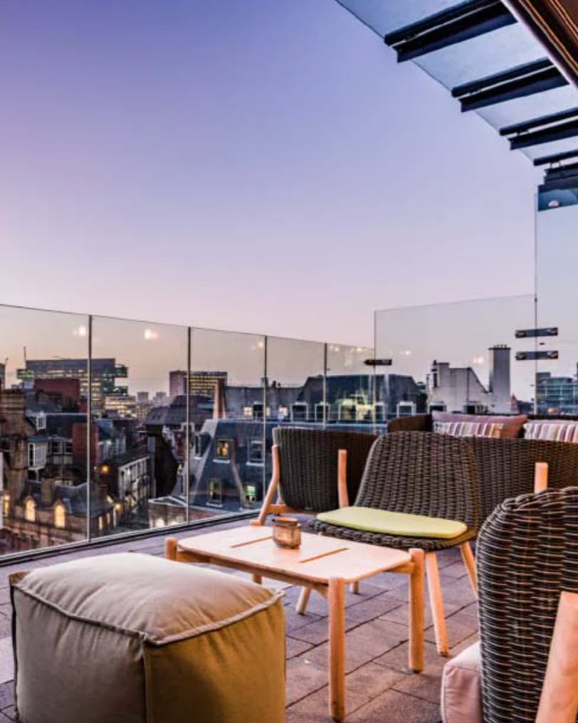 Stylish rooftop lounge with city skyline, perfect for upscale events and networking.