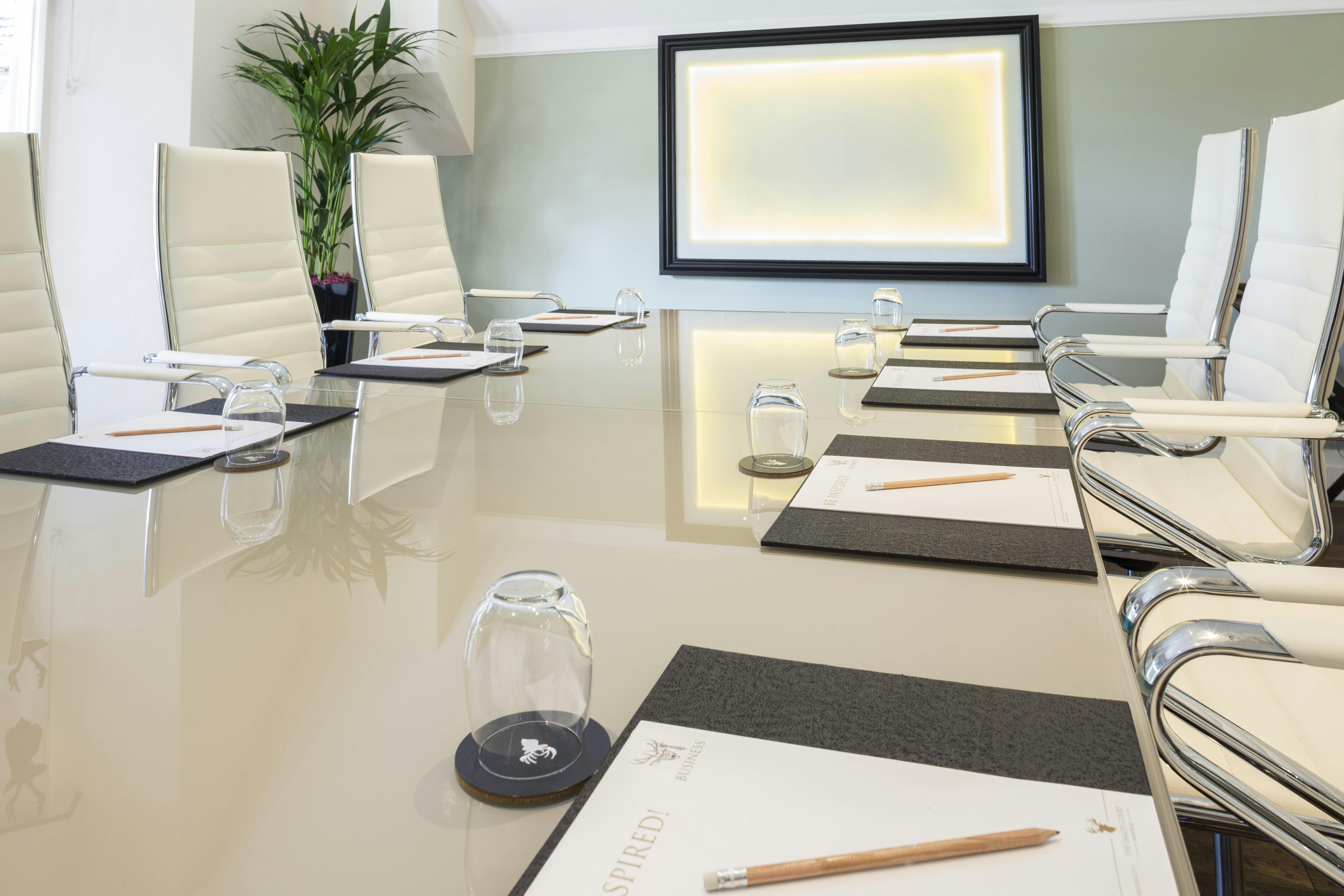 Modern Henley Suite conference room with polished table, ideal for meetings and brainstorming.