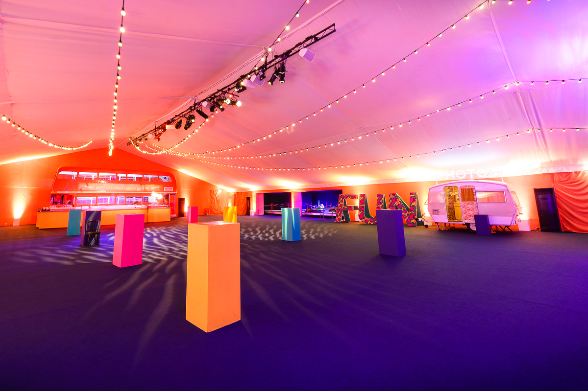 Vibrant event space at HAC with tent, colorful displays, ideal for product launches and gatherings. - Banner