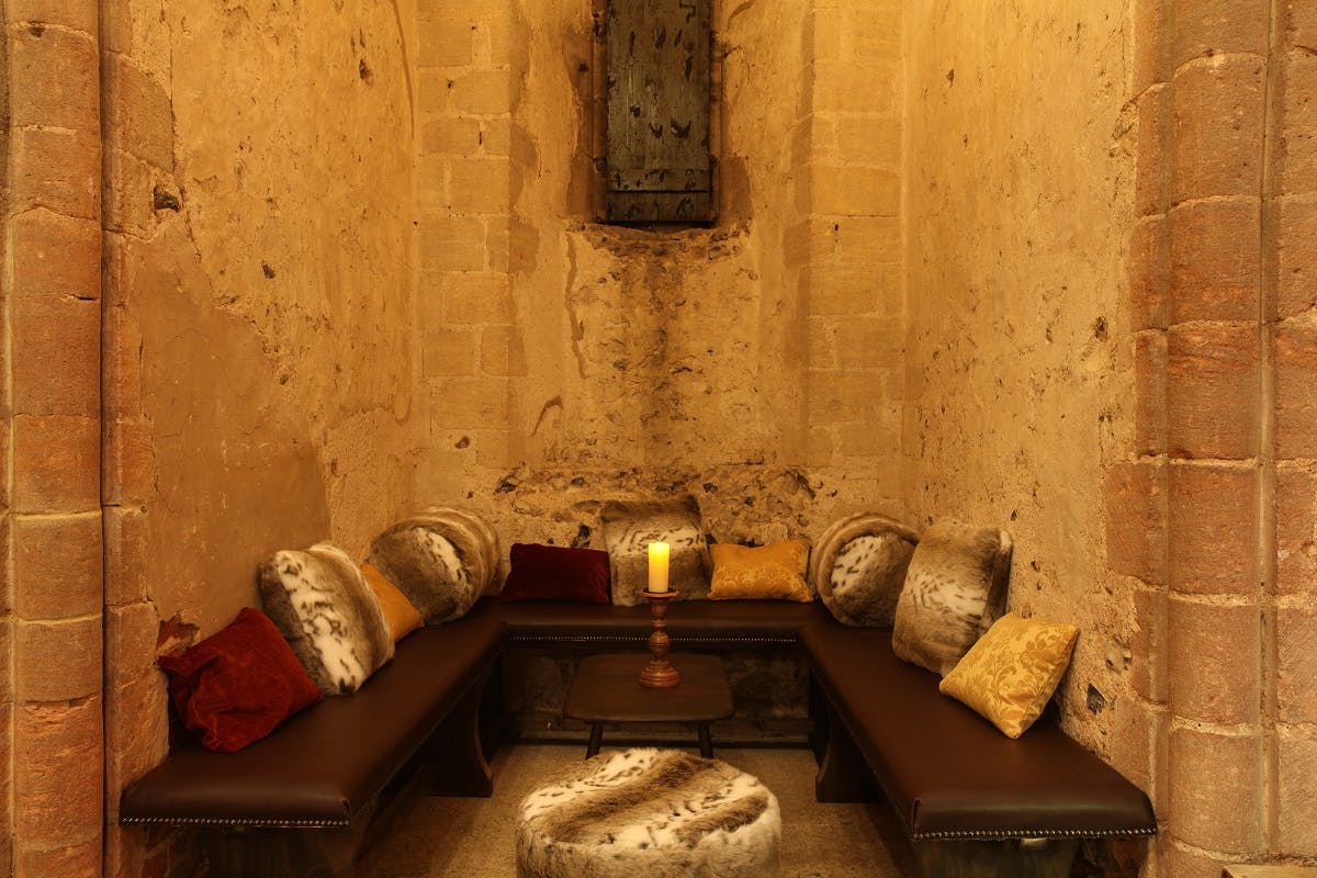 Cozy seating area in Hedingham Castle for intimate discussions and events.