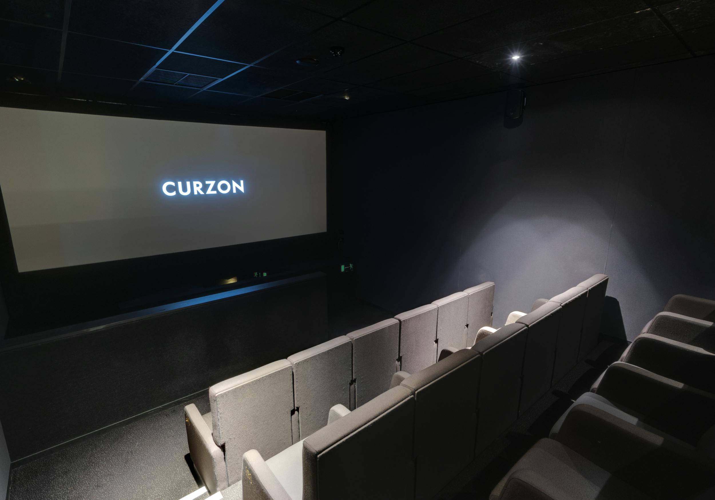 Modern screening room with large screen for intimate film screenings and corporate events.