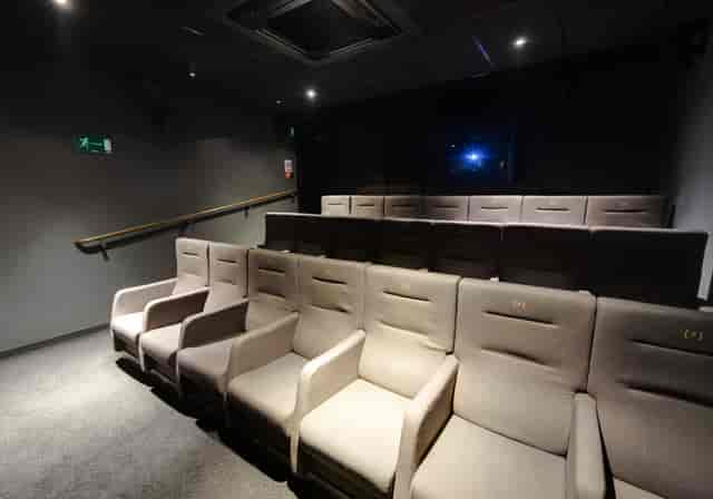 Intimate theater with plush seating for corporate meetings and private screenings.