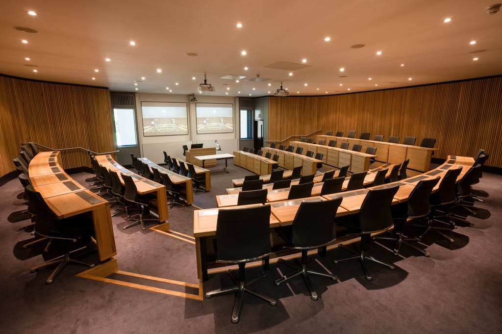 Modern lecture theatre with tiered seating at Saïd Business School, Oxford for corporate events.