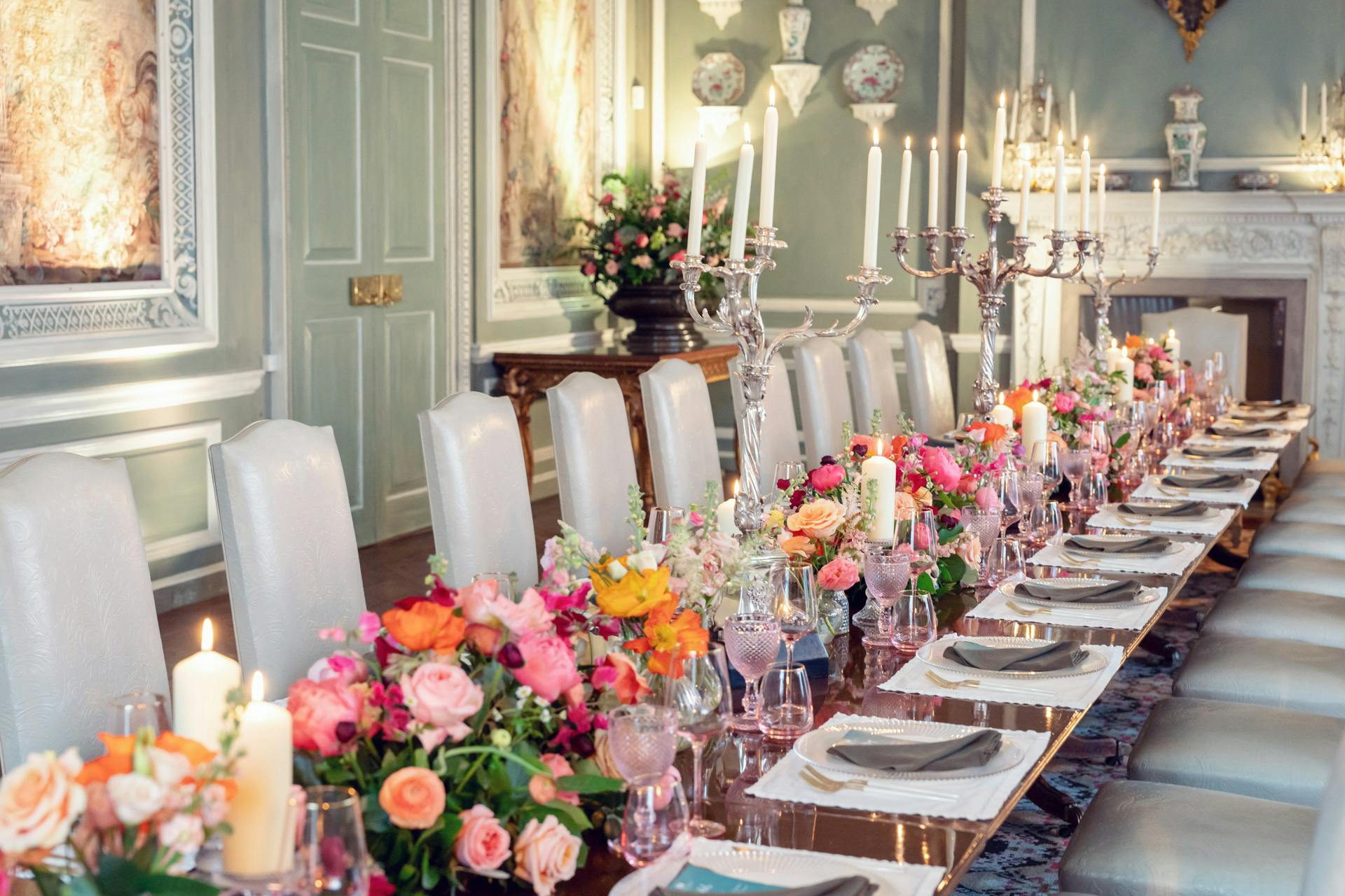 Elegant dining table at Leeds Castle, adorned with vibrant flowers for upscale events.