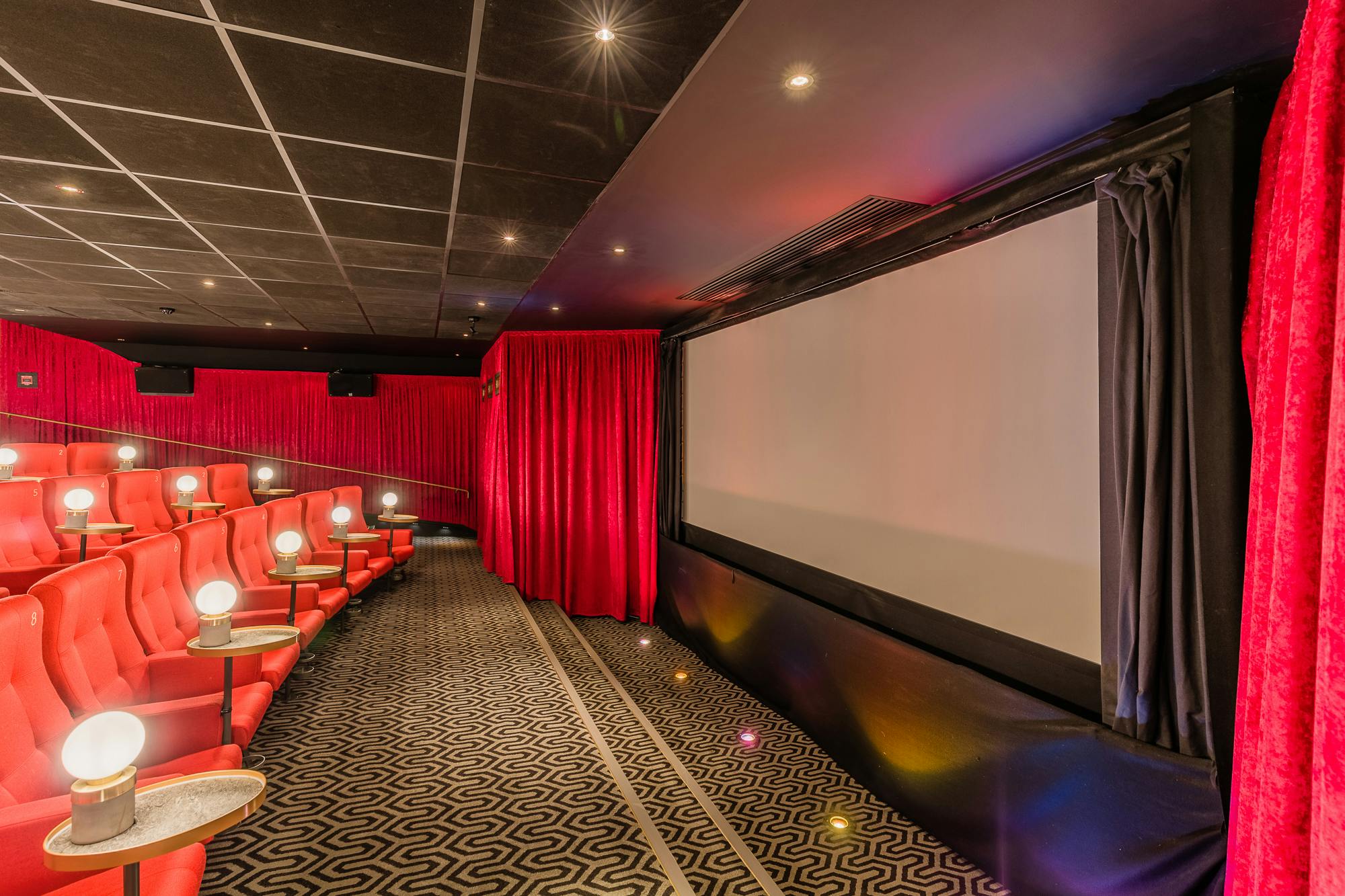 Intimate screening room with plush red seating for corporate events at Curzon Mayfair.