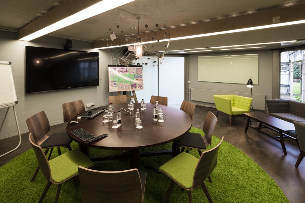 Modern meeting space at Egrove Park, featuring a circular table for collaboration.