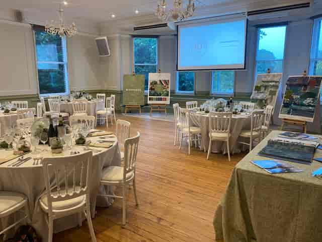Elegant event space in Winchester House with floral centerpieces, perfect for meetings and celebrations.