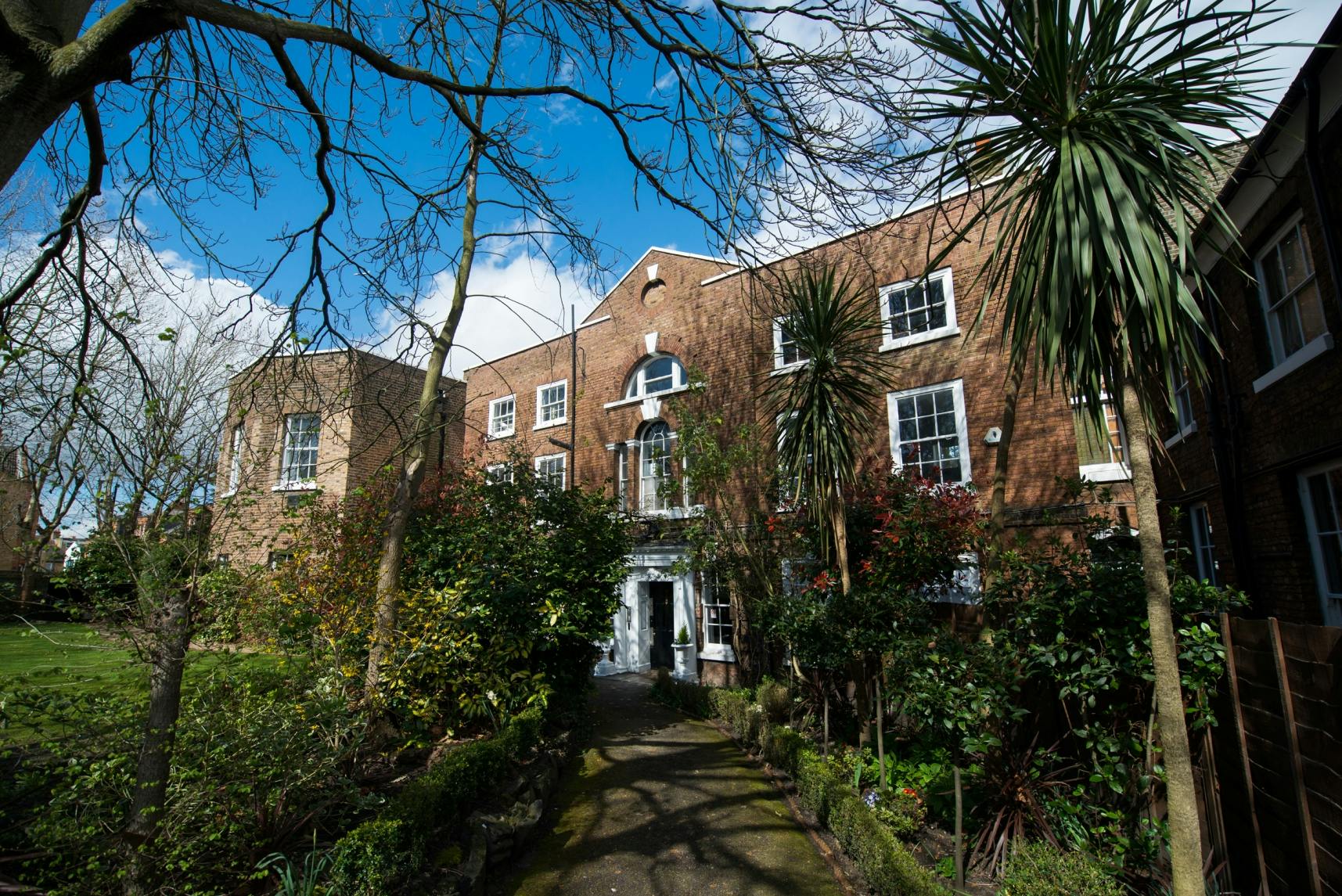 Charming Winchester House event space with lush greenery, ideal for weddings and meetings.