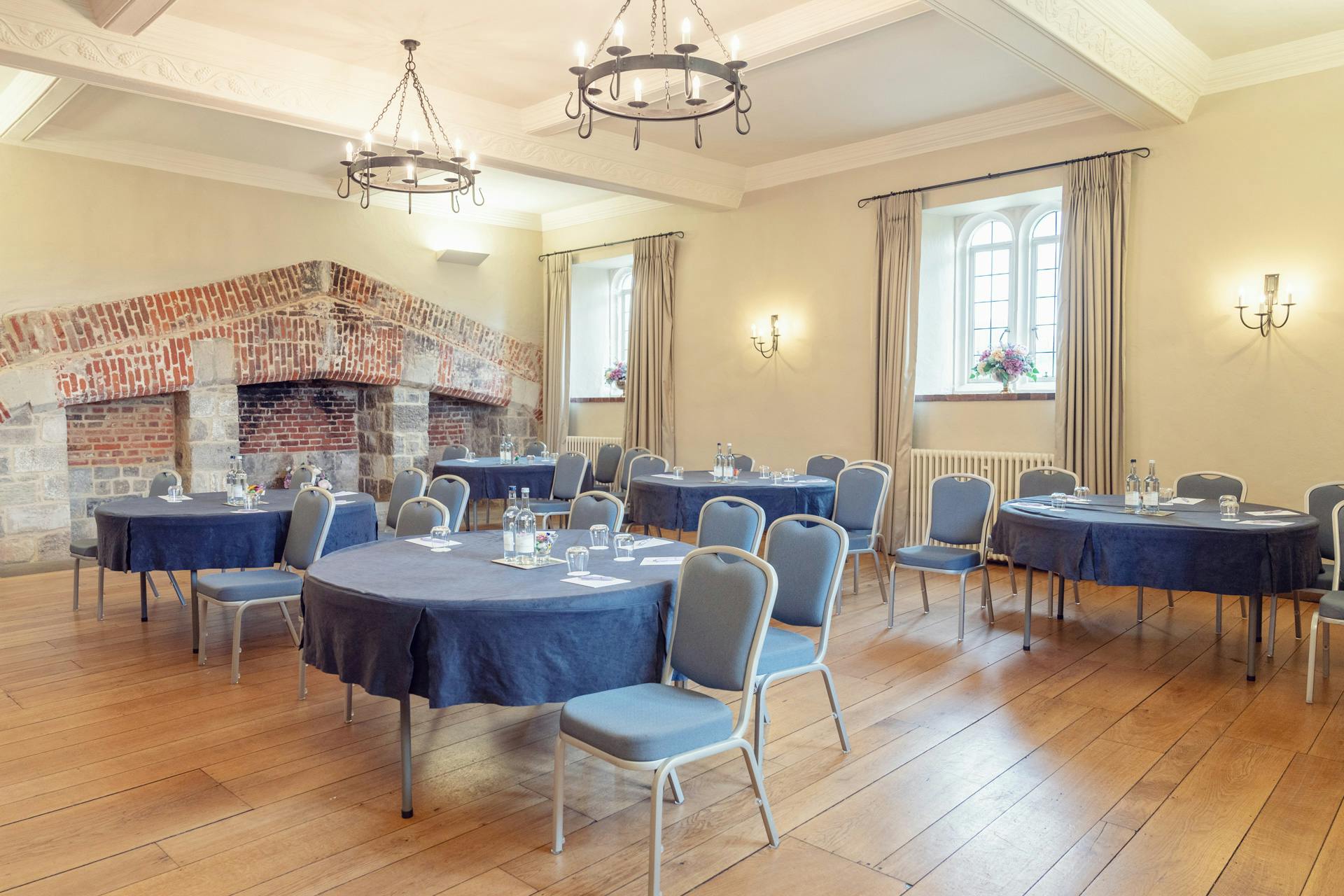 Maiden's Tower meeting room with round tables, ideal for workshops and conferences.