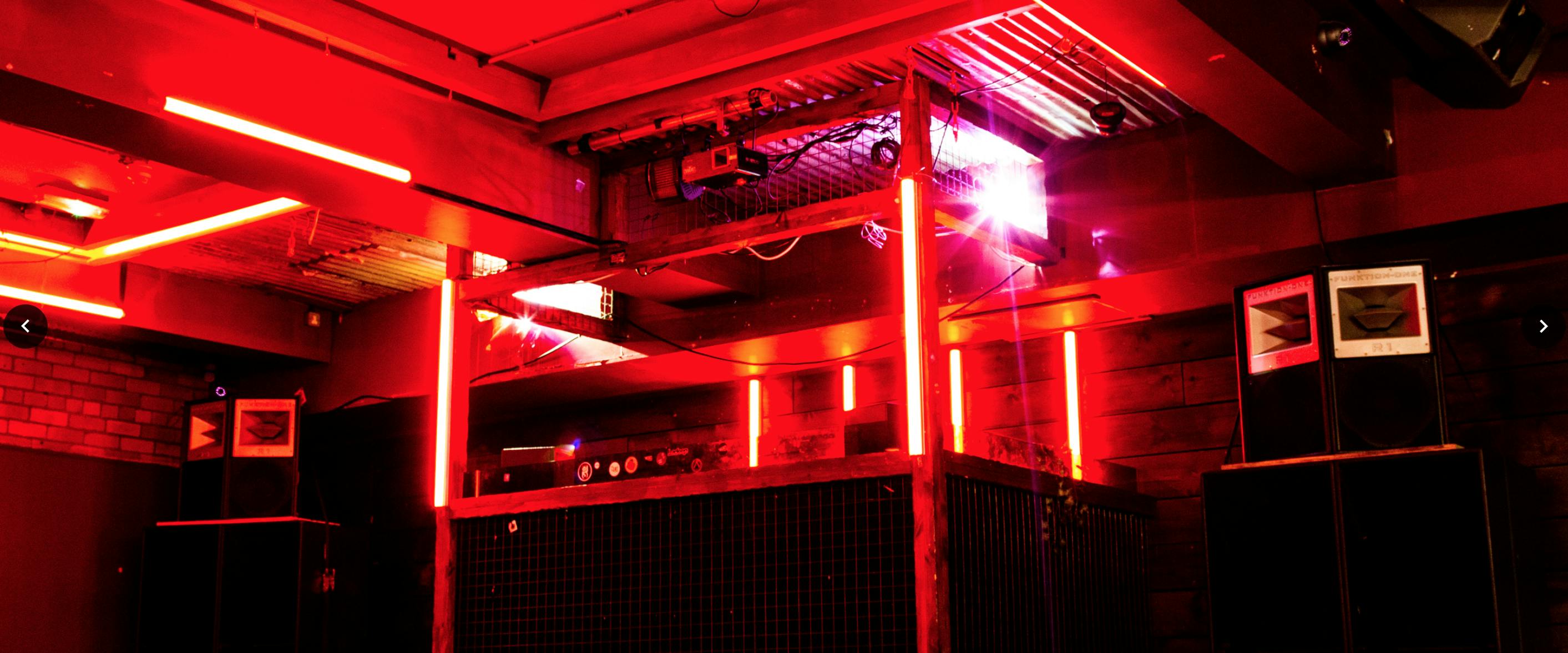 Vibrant event space at Brickhouse Social with red lighting for corporate and social gatherings.